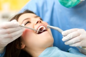 Dentist curing a female patient